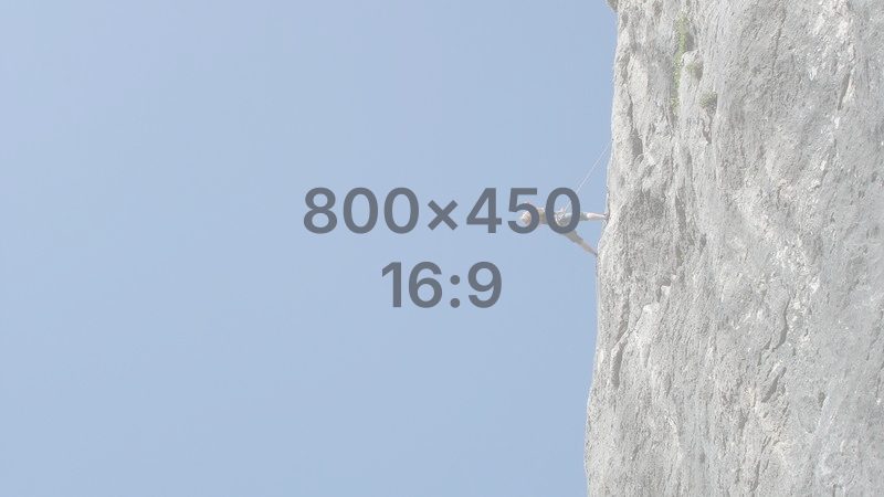 A phone resting precariously on a jagged mountain edge